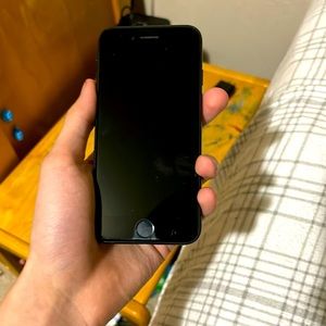 iPhone SE, with pride stickers on the back